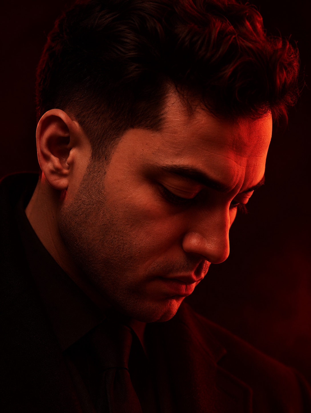 Portrait lit from one side in deep red